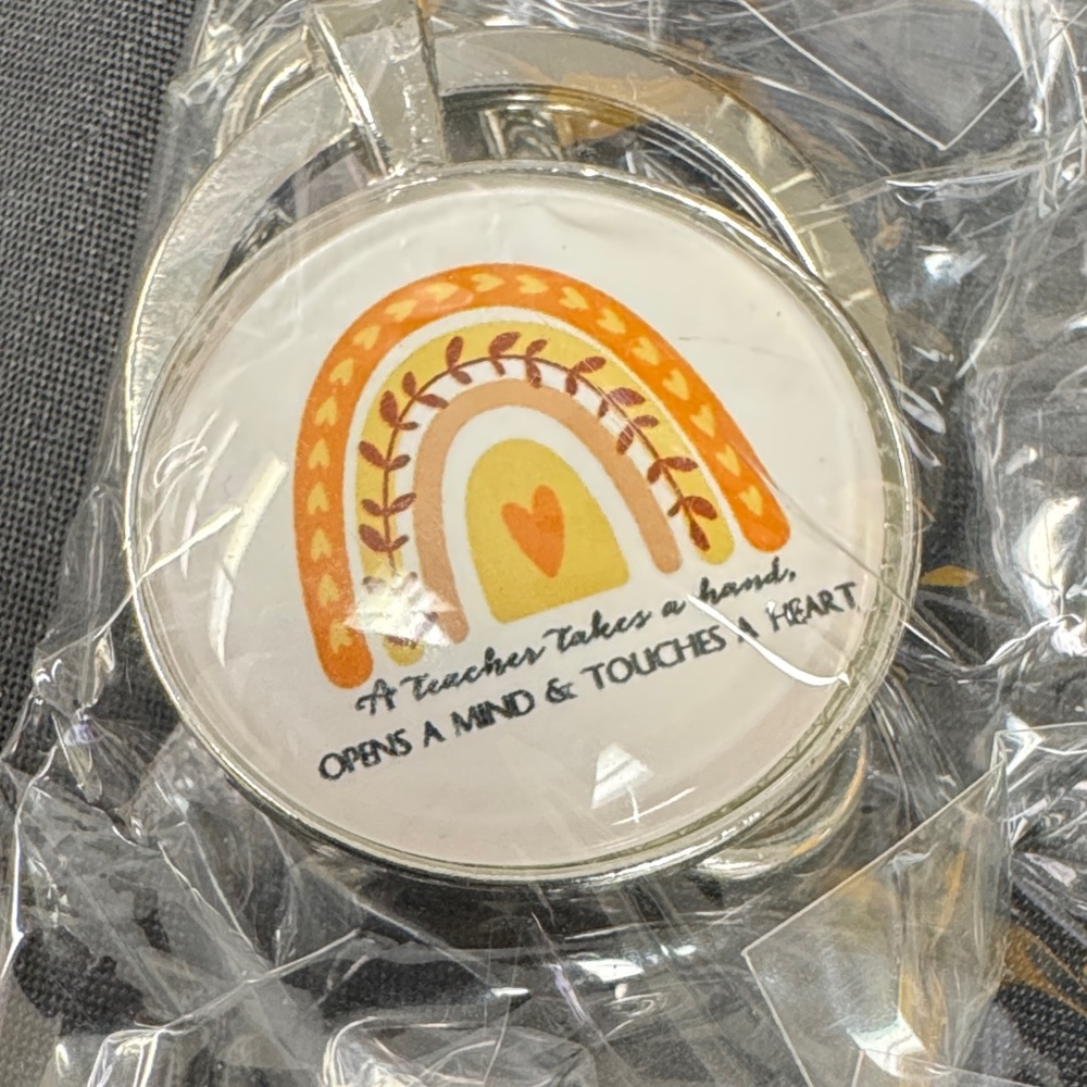 Inspirational Keychain with Rainbow Design A teacher takes a hand, opens a mind